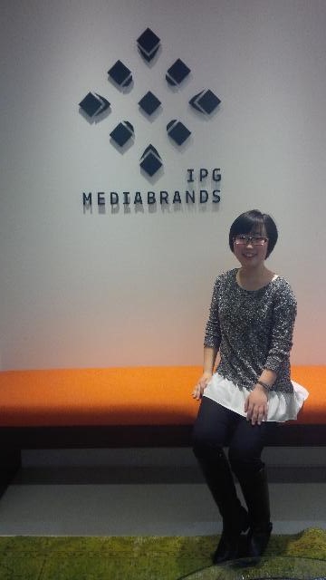 Xingyi poses in her office at Reprise Media, where she works as a Search Analyst